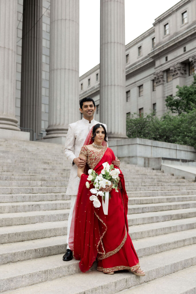 Couple sharing a quiet moment together while exploring the streets of New York City on their wedding day.
