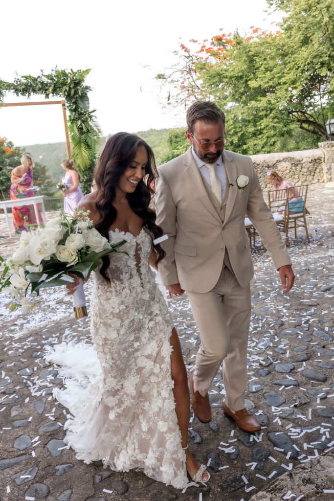 Intimate wedding ceremony with tropical florals and guests celebrating in a beautiful outdoor setting.
